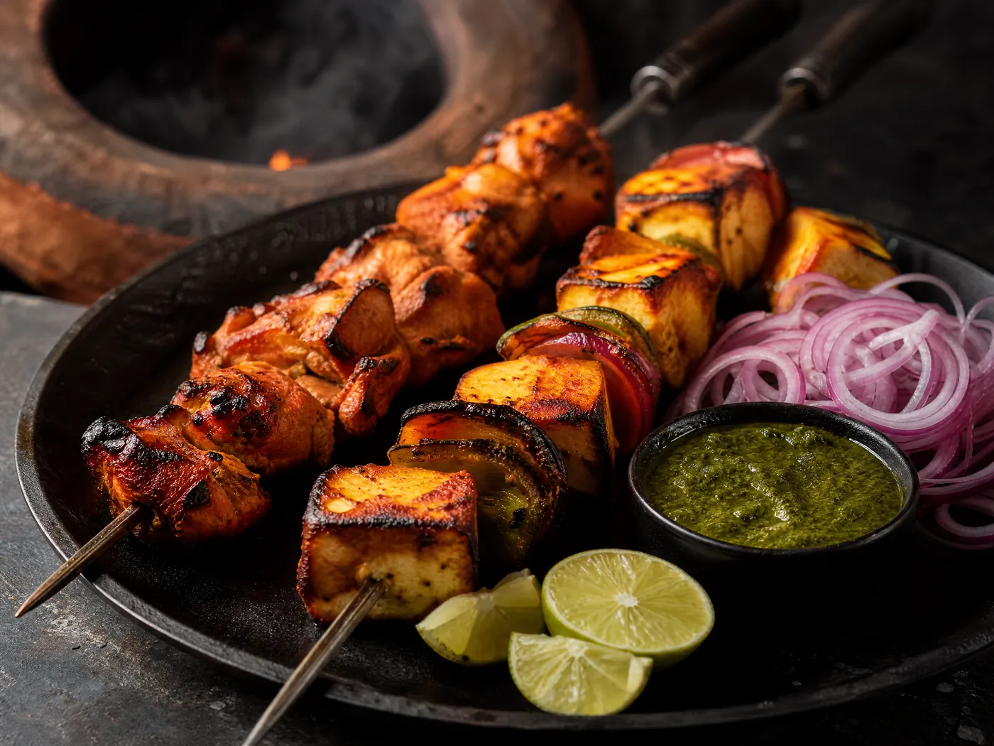 Chicken tikka and paneer tikka skewers fresh from the clay oven, with onion, lime and mint chutney.